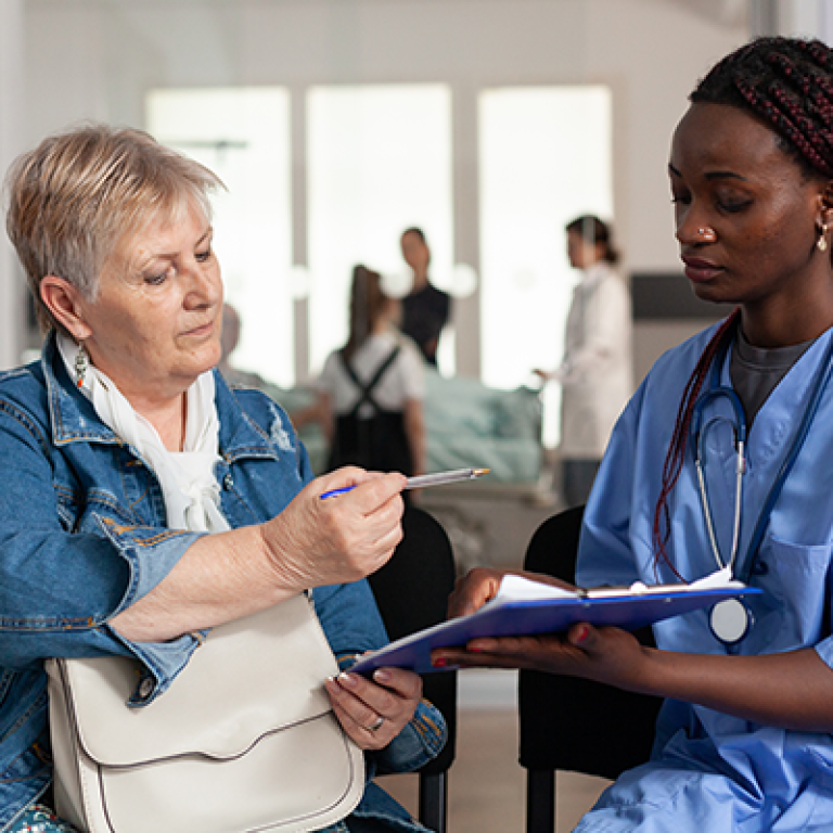 african-american-nurse-explaining-sickness-treatment-elderly-patient