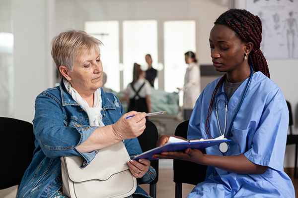 african-american-nurse-explaining-sickness-treatment-elderly-patient